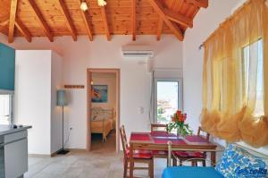 a kitchen and dining room with a table and chairs at Estella Studios in Elafonisos