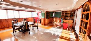 a kitchen and dining room with a table and chairs at Yuma D Homestay in Darjeeling