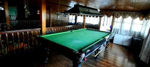 a pool table in the middle of a room at Yuma D Homestay in Darjeeling
