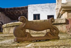 an old metal object sitting on the ground at Masseria Spina Resort in Monopoli