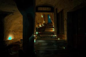 a stairway with lights in a cave at night at Masseria Spina Resort in Monopoli