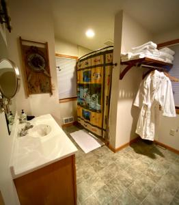 a bathroom with a sink and a shower with a mirror at Hannon House in Darby