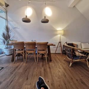 a living room with a wooden table and chairs at Oasis Inn in Hengchun South Gate