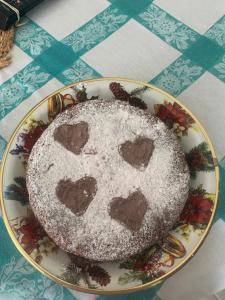 a cake with hearts on a plate on a table at B&B Audafra in Crotone