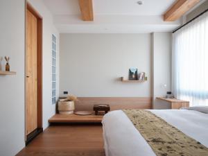 ein Schlafzimmer mit einem großen Bett und einem Fenster in der Unterkunft OR Inn in Hsinchu