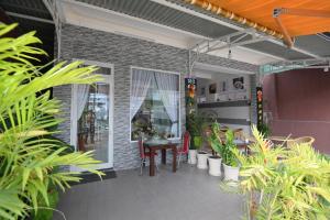 a patio with a table and chairs and plants at Villa SEVENBAY in Da Lat