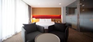 Postel nebo postele na pokoji v ubytování Ulsan City Hotel