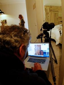 a man sitting in front of a camera with a laptop at Locanda Stella in Perugia