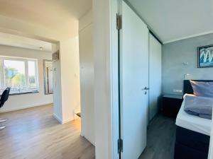 a bedroom with a bed and a sliding glass door at Penthouse mit Dachterrasse PIER 5.4 in Binz