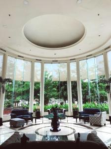 een lobby met banken en een tafel in een gebouw bij Aryaduta Makassar in Makassar