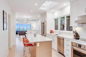 a kitchen with white cabinets and a counter top at Dream View Beach House in Victoria