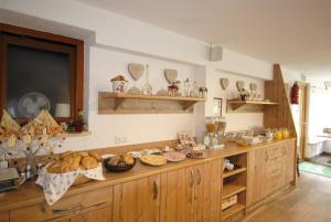 a kitchen with a counter with lots of food on it at Hotel Gasthof Seeblick in Zeutschach
