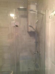 a shower with a glass door in a bathroom at Apartament Leśna Jarosławiec in Jarosławiec