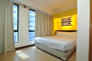 Ein Bett oder Betten in einem Zimmer der Unterkunft Hotel China Town 2