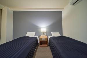 Postel nebo postele na pokoji v ubytování Hotel First Stay Amagasaki