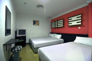Ein Bett oder Betten in einem Zimmer der Unterkunft Hotel China Town 2