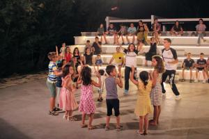 a group of children standing in front of a crowd at Villaggio Baia della Tufara in Vieste +58 photos