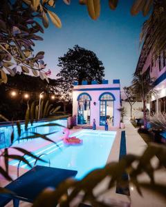 a swimming pool with a person in a pink flamingo at Bombora Surf Camp in Uluwatu