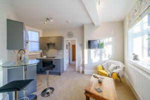 a kitchen and living room with a table at Upper Thames & Lower Thames - Stunning apartments in Henley on Thames