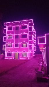 a building is lit up with purple lights at 300M FROM BEACH GLORIAS HOTEL BEACH VIEW in Mandarmoni