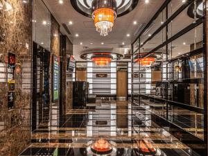 a lobby of a building with a chandelier at APA Hotel Shin Osaka Minamikata Ekimae in Osaka