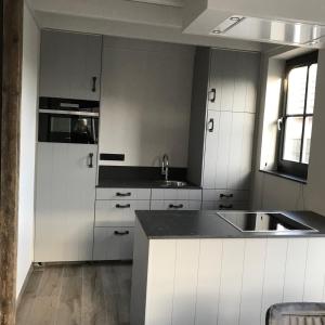 a kitchen with white cabinets and a sink at D'n Wasschappelsen Engel Windkracht 11 in Westkapelle