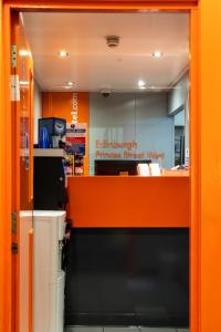 an entrance to the entrance to an orange stand yard at easyHotel Edinburgh in Edinburgh