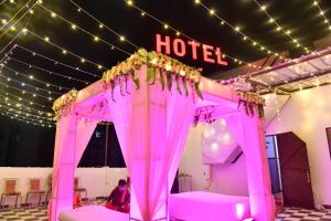 a pink canopy bed in front of a hotel at Hotel Sheetal in Jodhpur