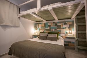 a bedroom with a large bed with a wall of tiles at MONTAÑAS in Sierra Nevada