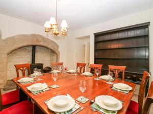 a dining room with a table with chairs and a fireplace at North Wing - Pitmedden Gardens in Ellon