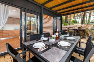 a dining room with a table and chairs at FantaSea Mobile Home Porton Biondi in Rovinj