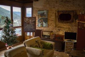 a living room with a christmas tree and a television at CASA CASTAÑÉ in Puente de Domingo Flórez