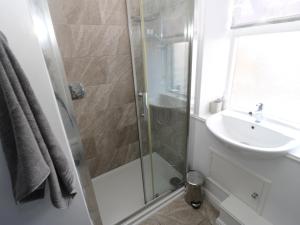 a bathroom with a shower and a sink at Townend Cottage in Keighley