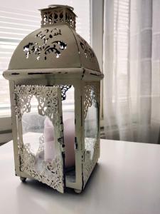 a lantern sitting on top of a table at Polku Apartaments in Imatra