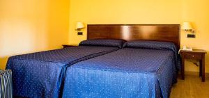 Кровать или кровати в номере Hotel Rural El Jardin