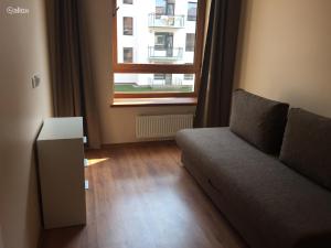 a living room with a couch and a window at Near PANORAMA apartment Self check-in Garage free in Vilnius