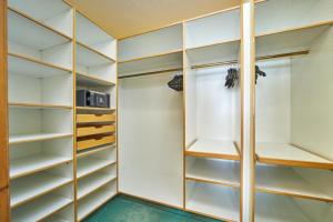 a walk in closet with glass doors and shelves at Parkhotel Wallgau in Wallgau