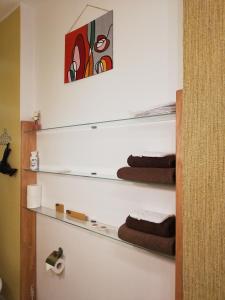 a bathroom with a shelf with towels on it at Zaļais namiņš in Ventspils