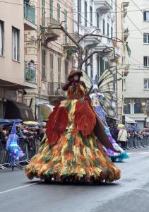 a group of people in costumes on a street at Via Palazzo Sanremo in Sanremo