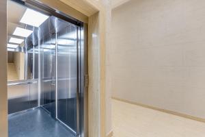 a glass door in a room with a window at Athos Square Apartments in Podgorica