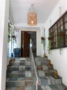 
a hallway with stairs leading up to a balcony at Muco Guest House in Johannesburg
