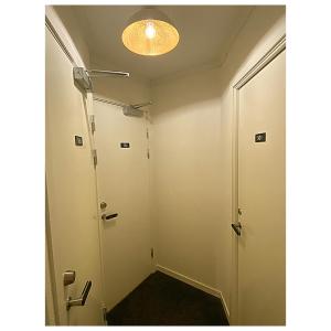 a hallway with a door and a light at Hotell Värend in Växjö +62 photos