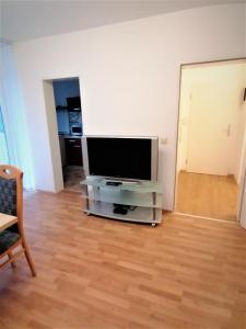 a living room with a flat screen tv on a stand at 2 Zimmer Apartment Hannover in Hannover