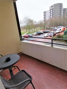 a table and a chair in front of a window at 2 Zimmer Apartment Hannover in Hannover