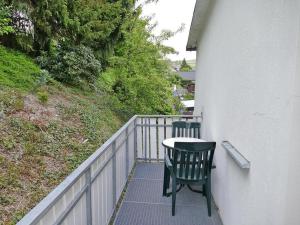 a table and two chairs on a balcony at Ferienwohnung Hacke in Schmallenberg