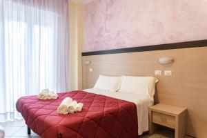 a hotel room with a bed with towels on it at Hotel Rubens in Rimini
