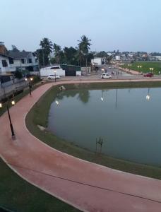 a pond in a park next to a street at Ameesha Lodge Apartment in Nugegoda
