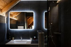 a bathroom with a sink and a mirror at Chalet Prestige l'Atelier Lodge in Les Deux Alpes +17 photos