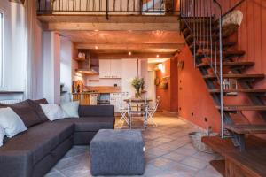 a living room with a couch and a staircase at Agriturismo Da Ciletta in San Bartolomeo al Mare
