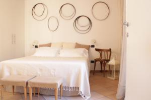 a bedroom with a bed with four mirrors on the wall at Agriturismo Da Ciletta in San Bartolomeo al Mare